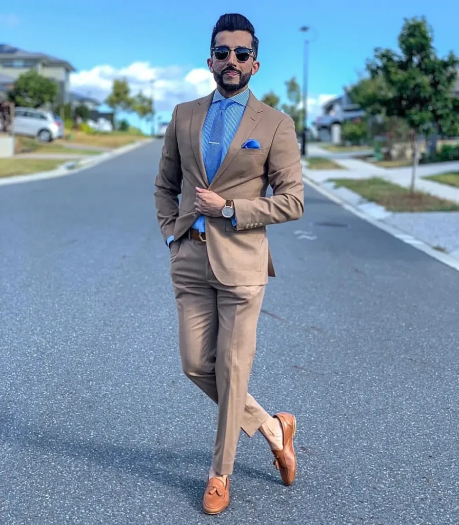 Tan suit paired with blue shirt